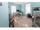 Spacious light blue bedroom featuring two windows and light-colored carpet at 7714 Sailwinds Pass, Port Richey, FL 34668