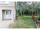 Front entryway with double doors, walkway and manicured green lawn at 7714 Sailwinds Pass, Port Richey, FL 34668