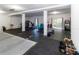 Versatile garage space featuring a painted floor, storage solutions and a sliding glass door at 7714 Sailwinds Pass, Port Richey, FL 34668