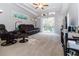 Cozy living room with ample natural light, plush seating, and a sliding door to the deck at 7714 Sailwinds Pass, Port Richey, FL 34668