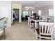 Spacious living and dining area with a dining table set for six, and bar seating area at 7714 Sailwinds Pass, Port Richey, FL 34668