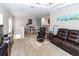 Spacious living room with neutral tones, plush carpeting, and a view to the dining area at 7714 Sailwinds Pass, Port Richey, FL 34668