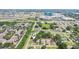 An aerial view shows the neighborhood, the highway and commercial buildings from afar at 7715 Deleuil Ave, Tampa, FL 33610