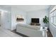 Bright living room with wood-look floors, neutral sofa, and a modern art piece on the wall at 7715 Deleuil Ave, Tampa, FL 33610
