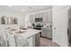 Modern open kitchen featuring an island with seating and stainless steel appliances at 7732 Wheat Stone Dr, Zephyrhills, FL 33540