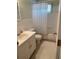 A clean, white bathroom with updated fixtures, a shower with tub, and a vanity at 8055 112Th St # 406, Seminole, FL 33772