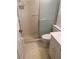 Compact bathroom with a glass-enclosed shower, toilet, vanity, and tiled floor at 8055 112Th St # 406, Seminole, FL 33772