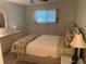 Comfortable bedroom with neutral tones, a dresser, and a well-lit window at 8055 112Th St # 406, Seminole, FL 33772
