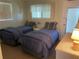 A bedroom featuring two twin beds with patterned bedding and ample natural light at 8055 112Th St # 406, Seminole, FL 33772
