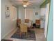 A dining room with glass top table, woven chairs, and tile flooring at 8055 112Th St # 406, Seminole, FL 33772