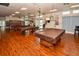 Spacious game room with multiple pool tables and hardwood flooring, perfect for entertaining at 8055 112Th St # 406, Seminole, FL 33772