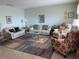 A living room with bright light walls, tile floor, and comfortable seating arrangement at 8055 112Th St # 406, Seminole, FL 33772