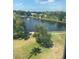 Scenic water view featuring a tranquil lake with a fountain, lush greenery, and clear blue skies at 8055 112Th St # 406, Seminole, FL 33772