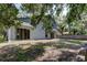 View of the backyard showcasing the large sliding glass doors at 8110 Pond Shadow Ln, Tampa, FL 33635