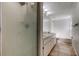 Bathroom featuring glass enclosed shower, tile floors, large vanity and garden tub at 8110 Pond Shadow Ln, Tampa, FL 33635