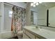 This bathroom features a shower/tub, vanity and mirror at 8110 Pond Shadow Ln, Tampa, FL 33635
