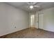 This cozy bedroom features neutral walls, carpet flooring, and a ceiling fan at 8110 Pond Shadow Ln, Tampa, FL 33635
