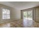 Bedroom featuring neutral paint and tile floors with large window and sliding glass door access to backyard at 8110 Pond Shadow Ln, Tampa, FL 33635