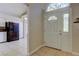 Welcoming home foyer with tile flooring, a front door with sidelights, and arched transom window at 8110 Pond Shadow Ln, Tampa, FL 33635