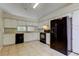 Efficient kitchen with white cabinets, neutral countertops, black appliances and tile flooring at 8110 Pond Shadow Ln, Tampa, FL 33635