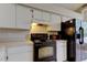 Bright kitchen featuring modern appliances, white cabinets, and ample counter space for cooking prep at 8110 Pond Shadow Ln, Tampa, FL 33635