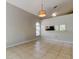 Open floor plan living room with ceramic tile, cathedral ceiling, and arched window at 8110 Pond Shadow Ln, Tampa, FL 33635