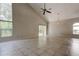 Spacious living room with tile flooring, a ceiling fan and light fixture and large windows at 8110 Pond Shadow Ln, Tampa, FL 33635