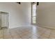 Large living room with tile floors, vaulted ceiling and a tall window at 8110 Pond Shadow Ln, Tampa, FL 33635