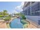 Gorgeous backyard with a pool, patio, and canal access, perfect for outdoor living at 915 Symphony Isles Blvd, Apollo Beach, FL 33572