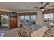 Bedroom with a ceiling fan and windows overlooking the canal at 915 Symphony Isles Blvd, Apollo Beach, FL 33572