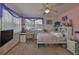 Comfortable bedroom featuring a cozy bed, dedicated workspace, and lots of wall decor at 915 Symphony Isles Blvd, Apollo Beach, FL 33572