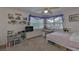 Bright bedroom with a cozy bed, study area, and ample natural light streaming through the window at 915 Symphony Isles Blvd, Apollo Beach, FL 33572