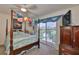 Comfortable bedroom with four poster bed and balcony access overlooking the beautiful water view at 915 Symphony Isles Blvd, Apollo Beach, FL 33572