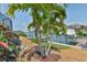 Scenic backyard view of a canal with a private boat dock and mature palm trees at 915 Symphony Isles Blvd, Apollo Beach, FL 33572
