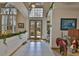 Bright foyer with a high ceiling, tile flooring, and a view of the landscaped front yard at 915 Symphony Isles Blvd, Apollo Beach, FL 33572