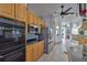 Kitchen area featuring stainless steel appliances, tile flooring, and open layout to living area at 915 Symphony Isles Blvd, Apollo Beach, FL 33572