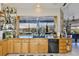 Kitchen with granite countertops, breakfast bar, and view of the canal from the sink at 915 Symphony Isles Blvd, Apollo Beach, FL 33572