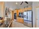 Kitchen with stainless steel appliances, tile floors, and light wood cabinets at 915 Symphony Isles Blvd, Apollo Beach, FL 33572
