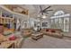 Bright living room with vaulted ceilings, large windows, and comfortable seating arrangement at 915 Symphony Isles Blvd, Apollo Beach, FL 33572