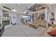 Open-concept living room features high ceilings, fireplace, and sliding glass doors to the outdoor area at 915 Symphony Isles Blvd, Apollo Beach, FL 33572
