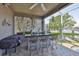 Inviting outdoor kitchen with bar seating, a built-in grill, and a serene waterfront view at 915 Symphony Isles Blvd, Apollo Beach, FL 33572