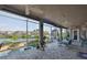 Expansive patio with ceiling fans, overlooking a pool and waterway, perfect for outdoor relaxation at 915 Symphony Isles Blvd, Apollo Beach, FL 33572