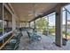 Spacious screened-in patio featuring bar seating, multiple ceiling fans, and views of the serene waterfront at 915 Symphony Isles Blvd, Apollo Beach, FL 33572