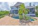 Private pool with a waterfall feature and lush tropical landscaping at 915 Symphony Isles Blvd, Apollo Beach, FL 33572