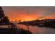 Beautiful sunset over waterway with gorgeous home exteriors at 915 Symphony Isles Blvd, Apollo Beach, FL 33572