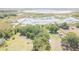 Aerial view of a rural property featuring lush greenery and a serene lake at 9722 Kenton Rd, Wesley Chapel, FL 33545