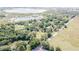 A wide aerial view showing the proximity of homes, lakes, roads, and tree lines at 9722 Kenton Rd, Wesley Chapel, FL 33545