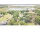 Aerial view of a home with a pool surrounded by mature trees at 9722 Kenton Rd, Wesley Chapel, FL 33545