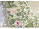 An aerial view of the property location, featuring a home near a lake with mature trees at 9722 Kenton Rd, Wesley Chapel, FL 33545