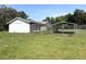 Backyard featuring chain link fence and a metal carport structure at 9722 Kenton Rd, Wesley Chapel, FL 33545